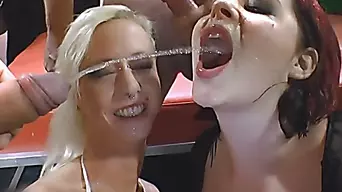 Two Kinky Sluts Blowing Cocks And Getting Pissed On At A Bukkake Party