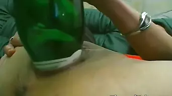 Sexy girl sticks a bottle in her pussy