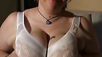 Naughty doll rubs her gigantic boobs while someone puts lot of oil on them!