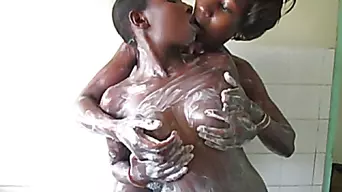 Soapy African Lesbians cuddling in the shower while washing.